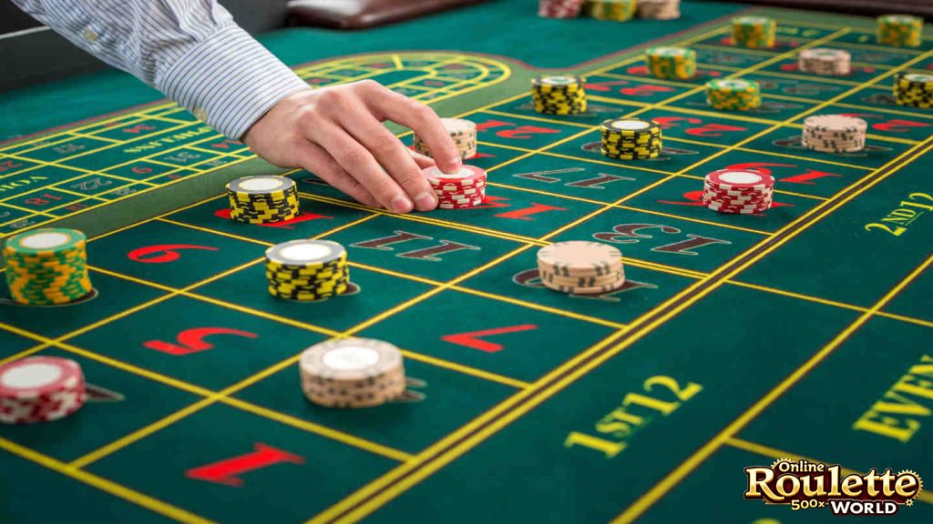 A stack of casino chips next to a pen and paper, illustrating the record-keeping aspect of the Labouchere roulette strategy